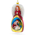 Guardian Angel over Nativity Glass Christmas Ornament