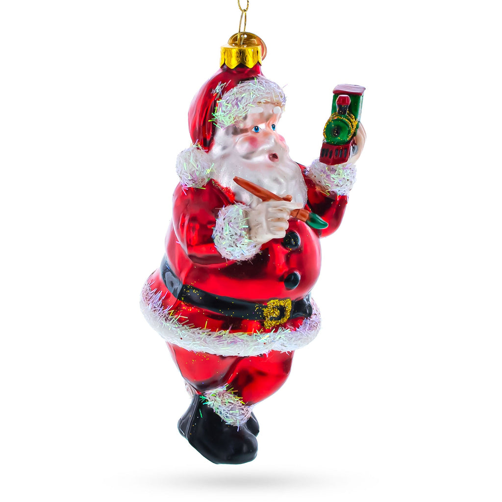 Santa Decorating the Train Glass Christmas Ornament