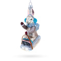 Bunny Sledding with Earmuffs Glass Christmas Ornament