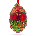 Red and Green Leaves on Red Glass Egg Ornament 4 Inches